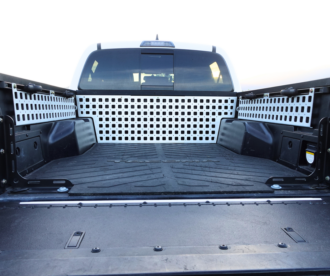 BPF 05-23 Tacoma bed Molle panels installed on truck bed sides and front, featuring durable, powder-coated metal with multiple attachment points for versatile overlanding and storage solutions.