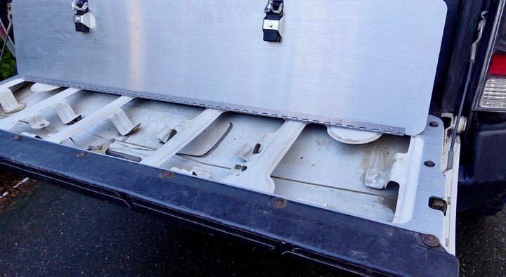 BPF 2005-2015 Toyota Tacoma Tailgate Panel installed on an open truck tailgate, showcasing its heavy-duty CNC fabricated aluminum construction and secure mounting points.