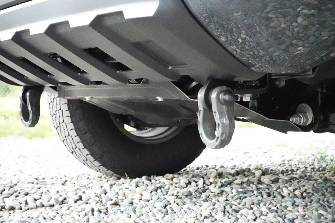 Close-up view of heavy-duty BPF 2024+ Tacoma Recovery Points mounted on the underside of a truck near the rear tire, designed for secure towing and recovery.