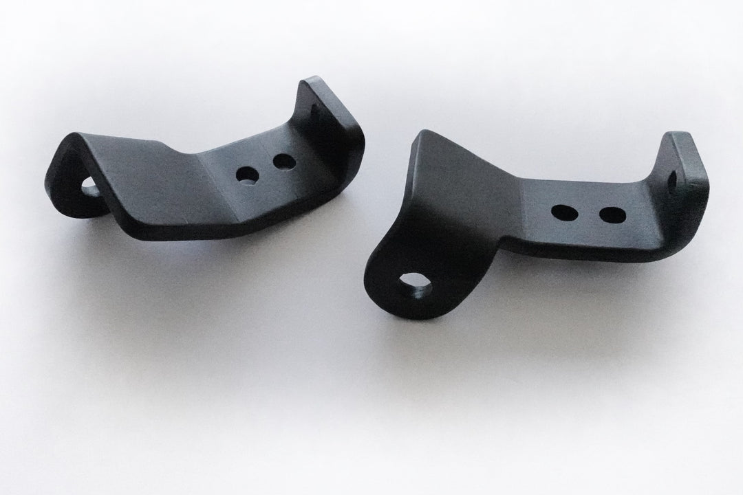 Pair of black powder-coated metal brackets designed as BPF 2024+ Tacoma Recovery Points for secure and durable vehicle recovery attachment.