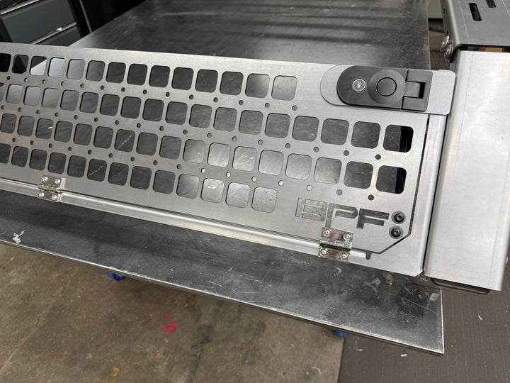 Close-up view of a powder-coated steel bed rack section with molle panel holes, featuring the Bullet Proof Fabricating logo, part of the 05-26 Tacoma Bed Rack fits 2nd,3rd and 4th gen Tacomas.