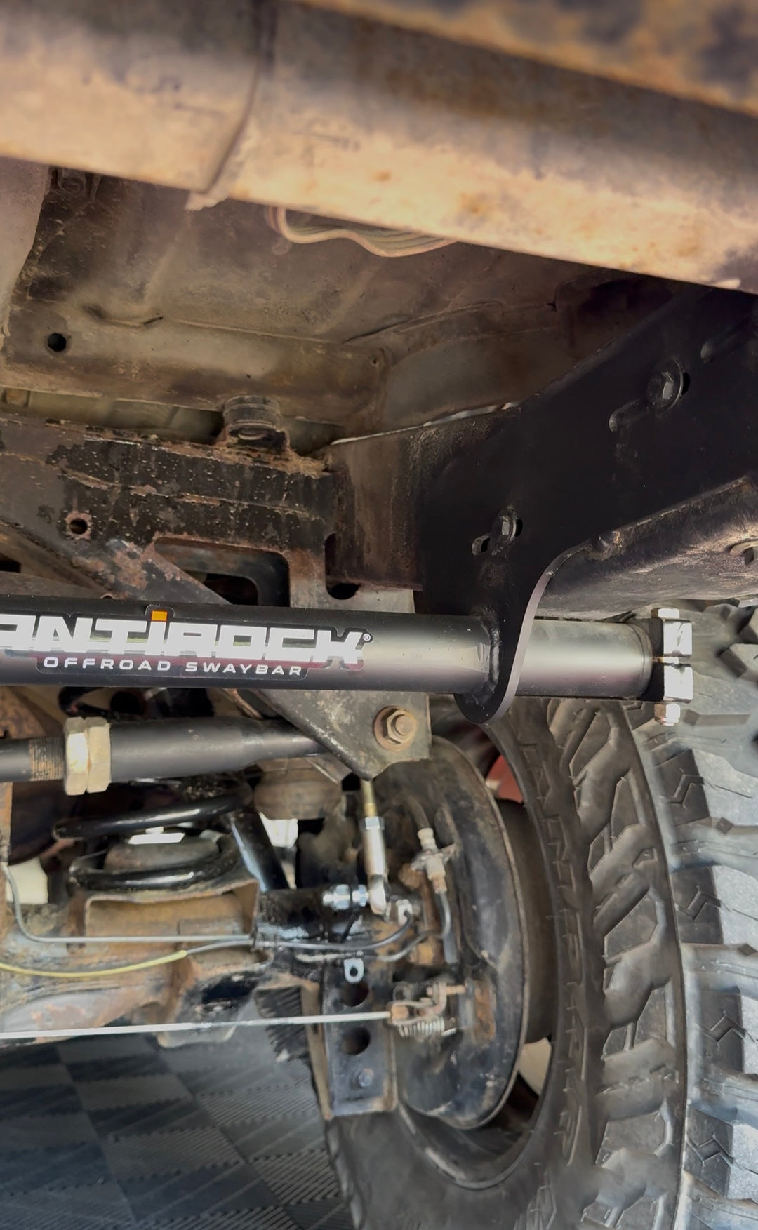 BPF 80 Series Land Cruiser RockJock AntiRock Frame Mounting Plates installed under the vehicle with frame reinforcement and sway bar hardware visible
