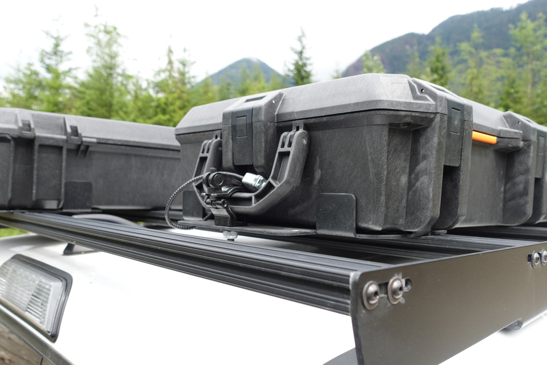 BPF Universal Pelican Vault V800 and V730 Case Mounting brackets securing heavy-duty protective cases on a roof rack, designed for overlanding gear and outdoor storage.
