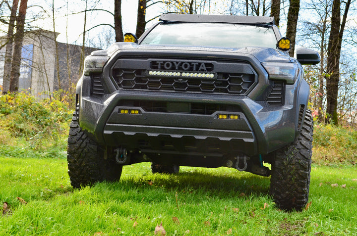 Front view of a rugged off-road truck featuring the 2024 Trailhunter Grille with BPF letters, showcasing a bold design with integrated LED lights and durable construction.