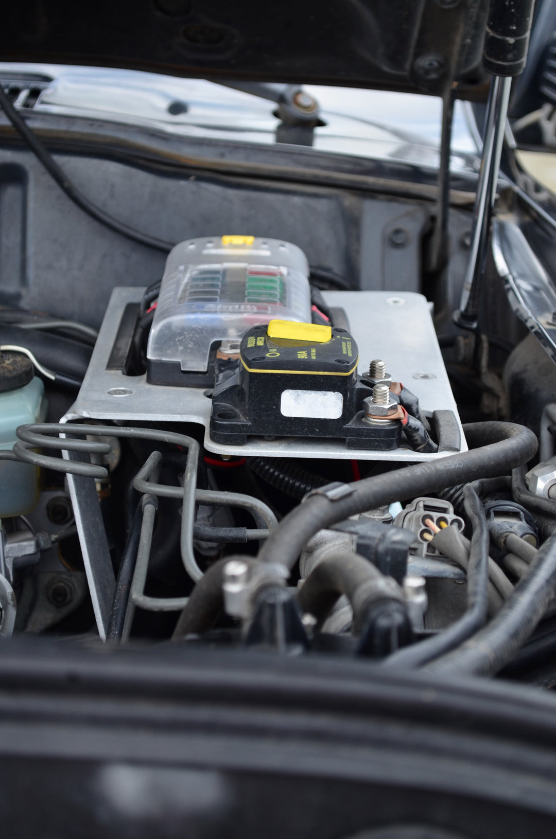 BPF 80 series Land cruiser Fuse block mount installed securely in engine bay, featuring durable metal construction and organized wiring for reliable electrical distribution and protection.