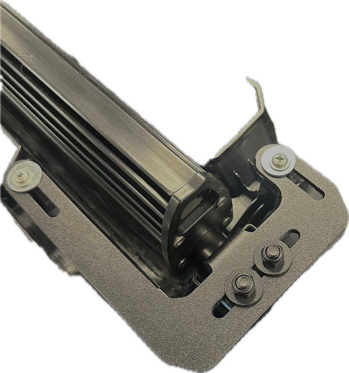 Close-up of the BPF 2024+ Tacoma TRD Pro and Trailhunter Universal Light Bar Bracket in durable textured metal finish with adjustable mounting slots and bolts.