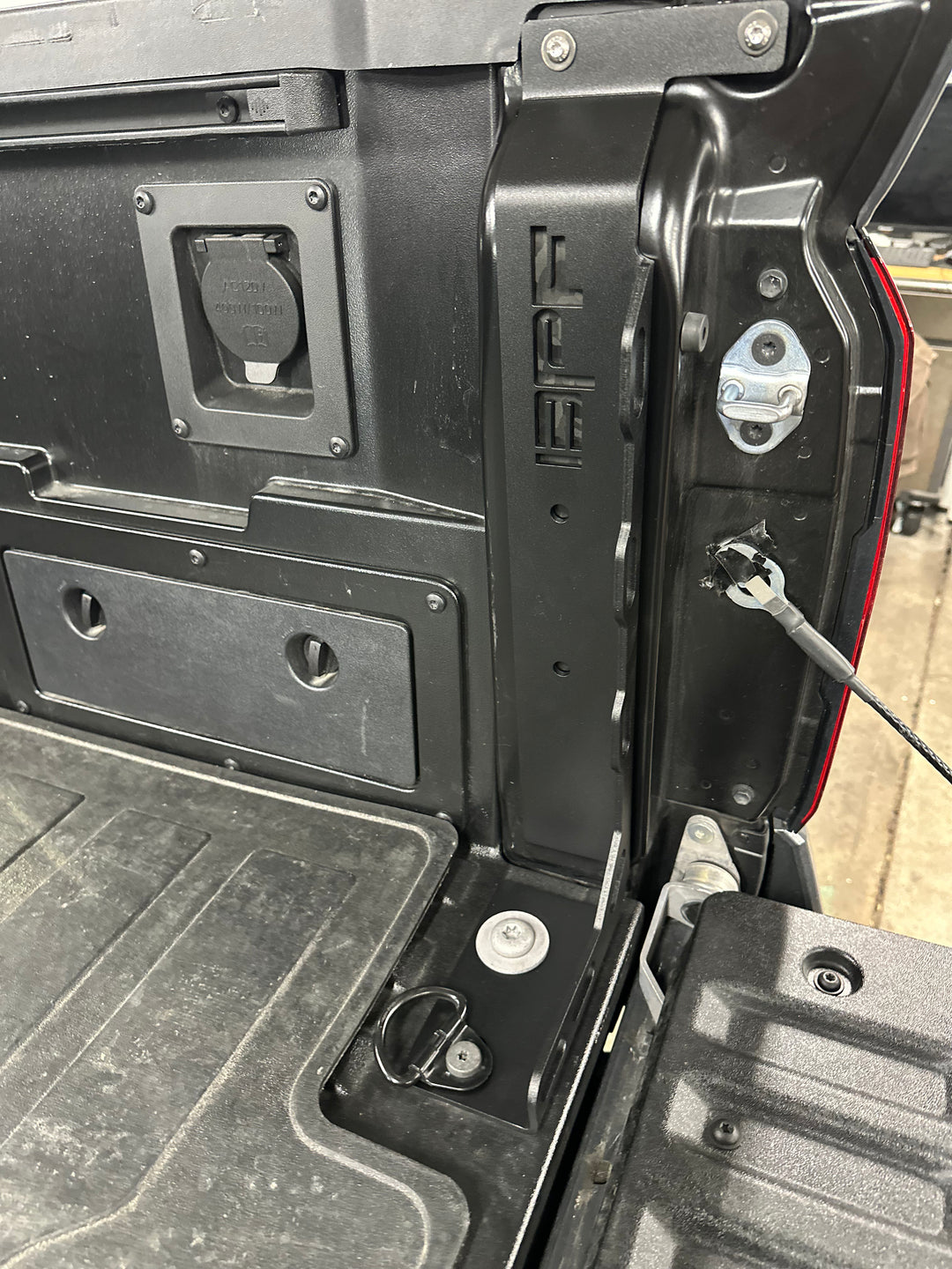 Close-up view of the black BPF 2024-2025 Toyota Tacoma Bed Stiffeners installed in the truck bed corner, showcasing bolt-on hardware and OEM fitment details.
