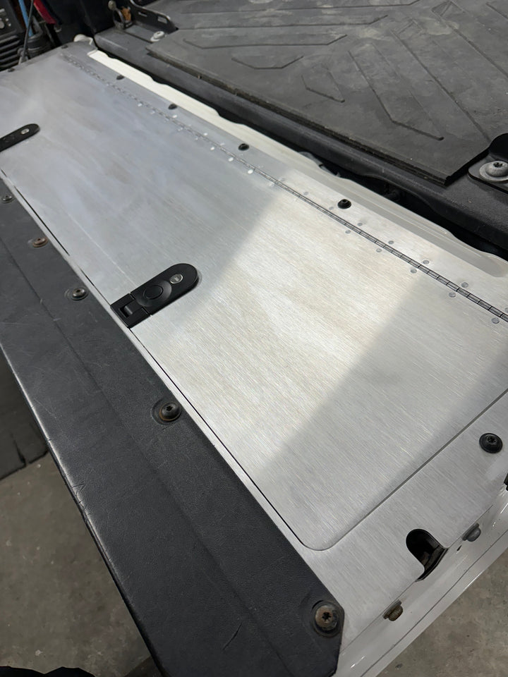BPF 2016-2023 Toyota Tacoma Tailgate Panel with brushed aluminum finish and secure mounting hardware shown installed on a truck tailgate