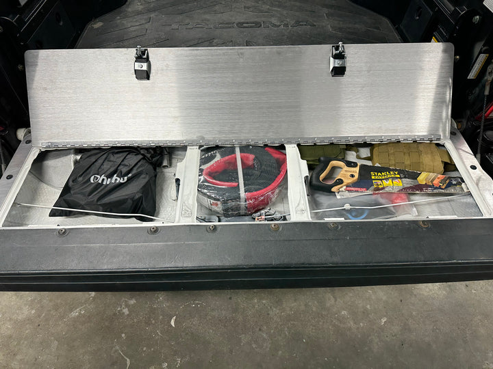 BPF 2016-2023 Toyota Tacoma Tailgate Panel shown open with organized recovery gear and storage compartments inside a truck bed