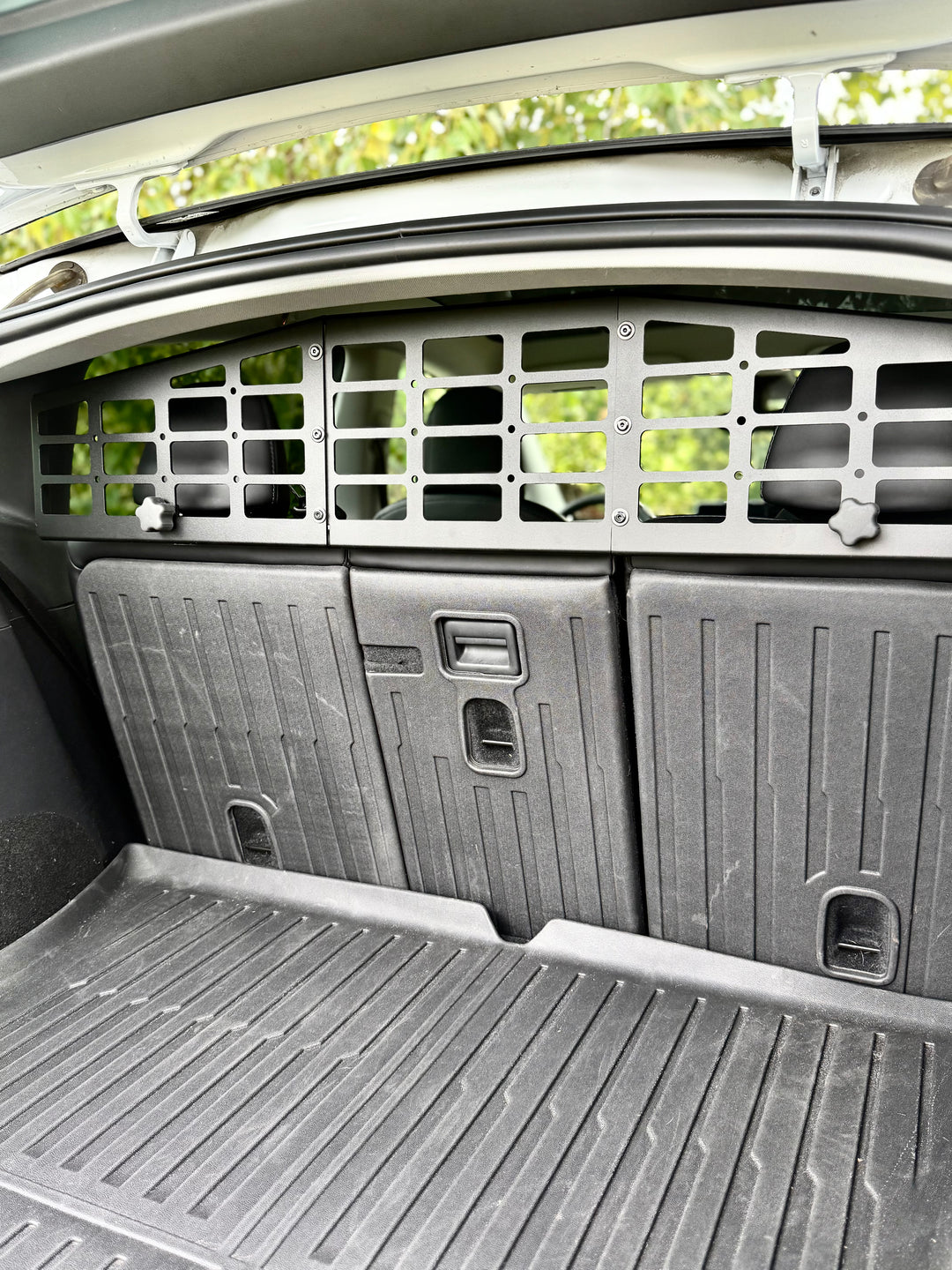 BPF Molle Style Pet Barrier Tesla Model Y 2020-CURRENT installed behind rear seats, black metal grid design for secure separation and durable protection inside the cargo area.