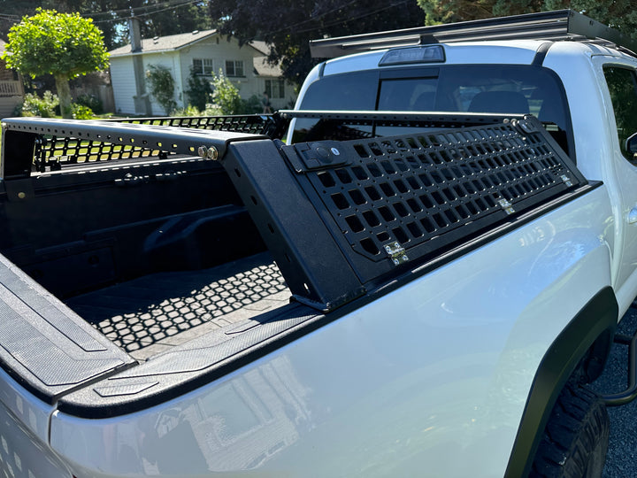 05-26 Tacoma Bed Rack fits 2nd,3rd and 4th gen Tacomas installed on white truck with black mesh panels and rugged off-road setup in backyard setting