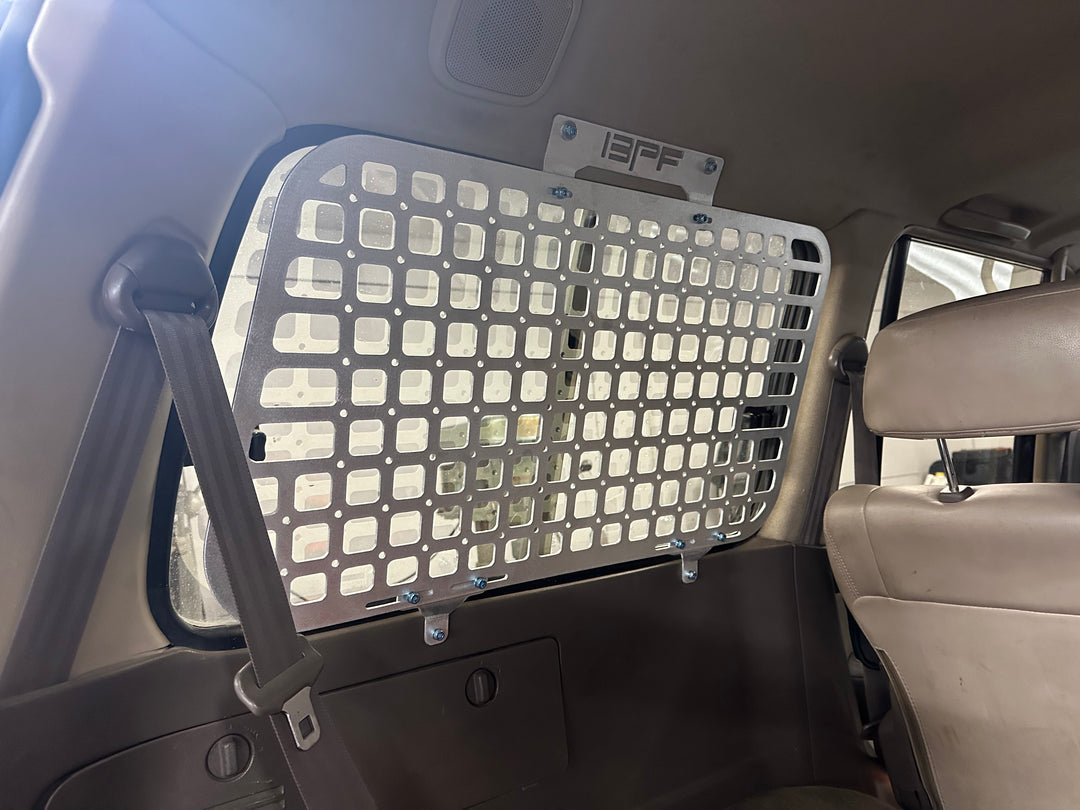 BPF 1990-1997 Toyota Land Cruiser Storage Panels installed inside a vehicle, featuring a CNC fabricated metal grid designed for durable overlanding gear organization and secure storage.