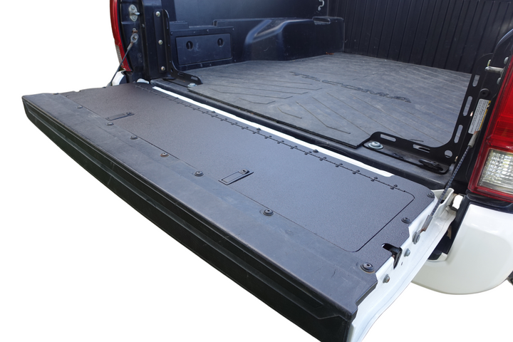 BPF 2016-2023 Toyota Tacoma Tailgate Panel installed on a white Tacoma with a textured black surface designed for durability and enhanced tailgate protection.