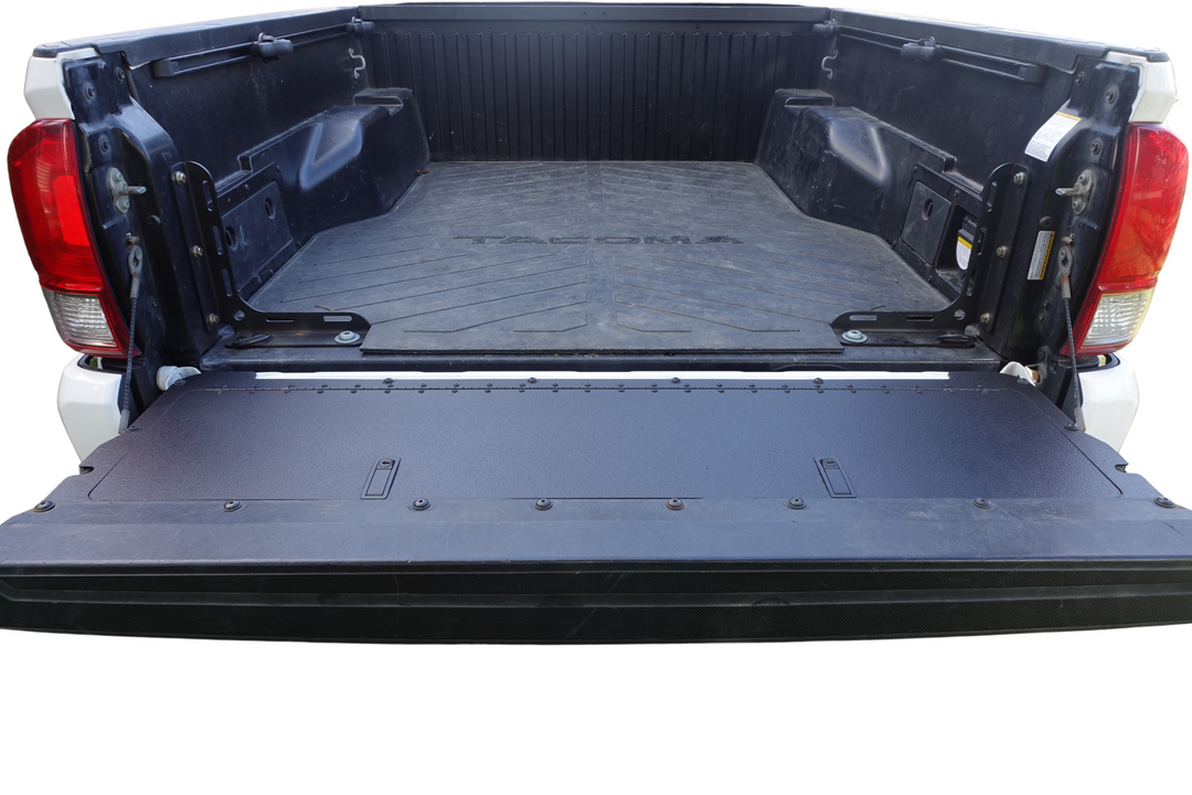 Open truck bed showcasing the installed BPF 2016-2023 Toyota Tacoma Tailgate Panel in a powder-coated black finish, designed for OEM fitment and durability.