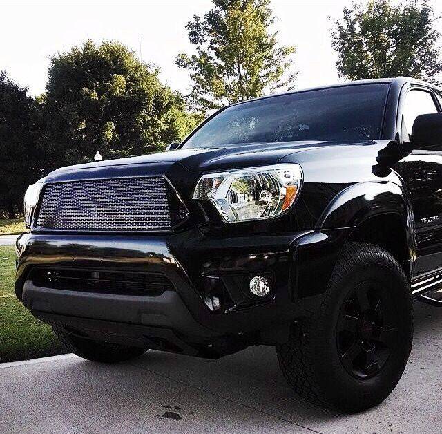 Black Toyota Tacoma featuring a BPF Completed 2012-2015 Toyota Tacoma Grill with a rugged mesh design, enhancing the truck&