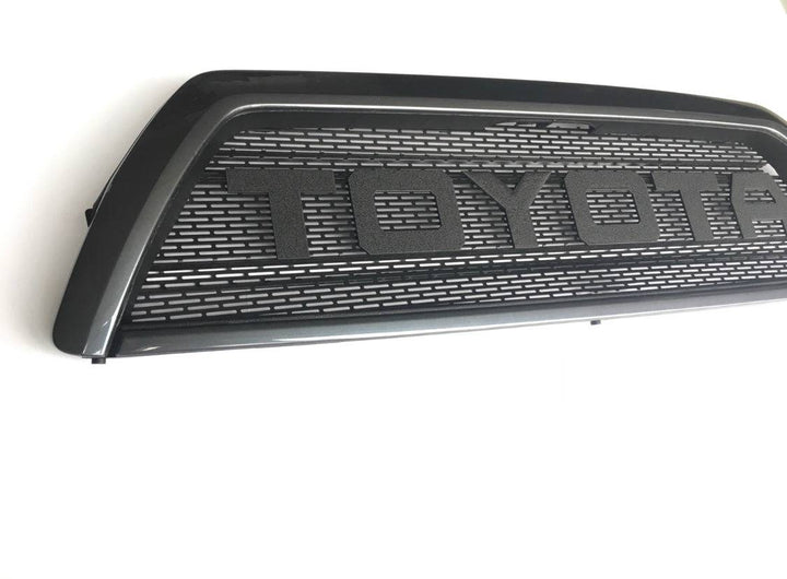 BPF 03-09 Toyota 4runner Grill in matte black finish featuring a bold Toyota logo with a rugged grill mesh design for enhanced airflow and durability.