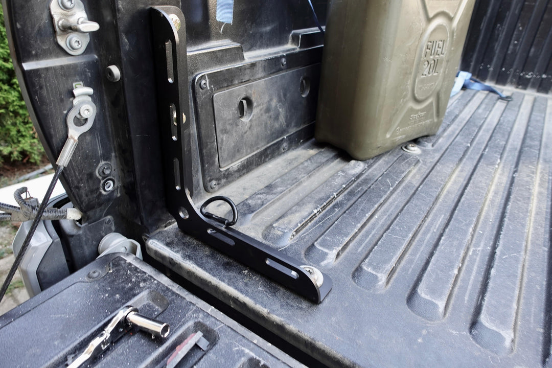 BPF 2005-2023 Toyota Tacoma Bed Stiffeners installed in truck bed corner, showing sturdy black powder-coated CNC fabricated metal support with tool-free install features.