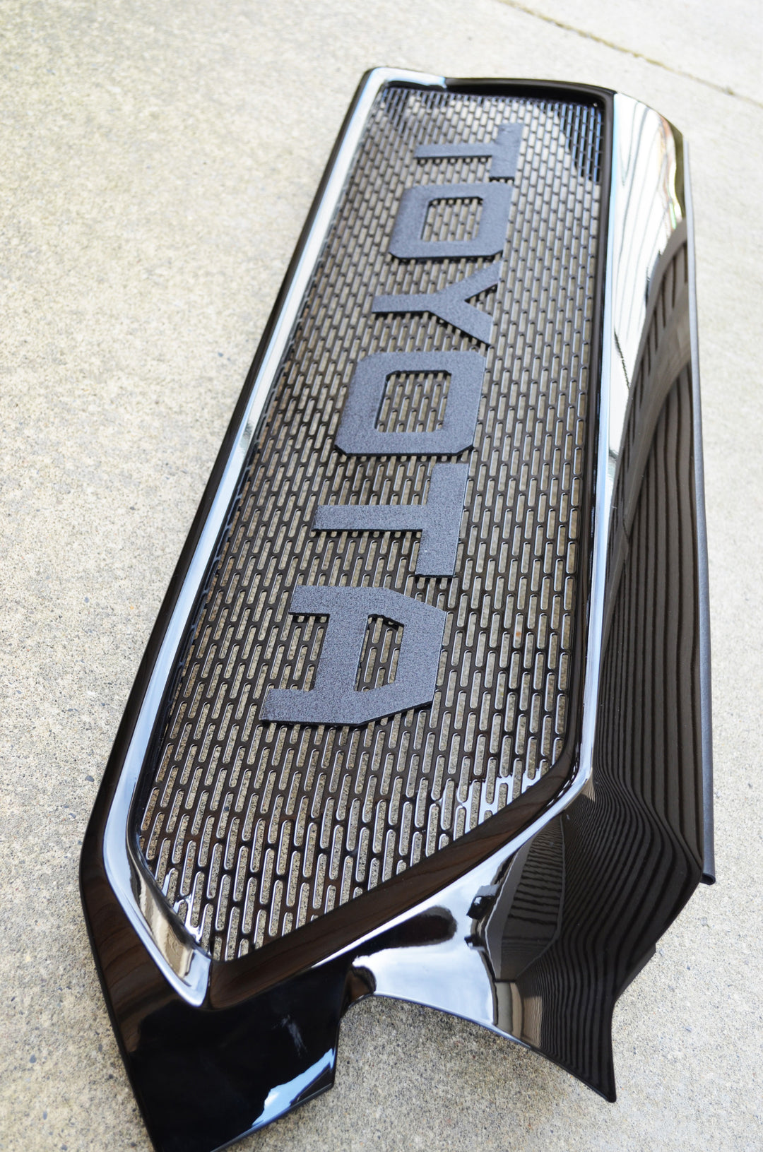 BPF 2012-2015 Toyota Tacoma Mesh and Lettering with black textured mesh and bold raised letters, designed for durable OEM fitment and stylish Tacoma customization.