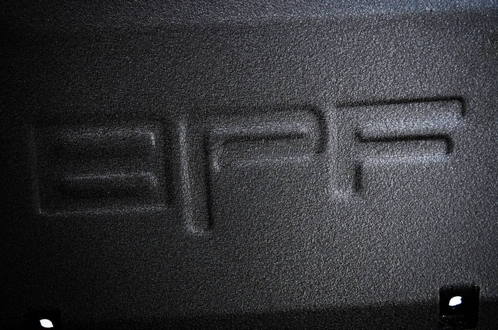 Close-up view of the textured surface with embossed BPF logo detail on the BPF 2005-2015 Toyota Tacoma Skid Plate, showcasing durable powder-coated finish.