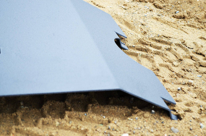 BPF 2005-2015 Toyota Tacoma Skid Plate with powder-coated finish resting on sandy ground, showcasing durable construction and precise CNC fabrication for Toyota Tacoma protection.