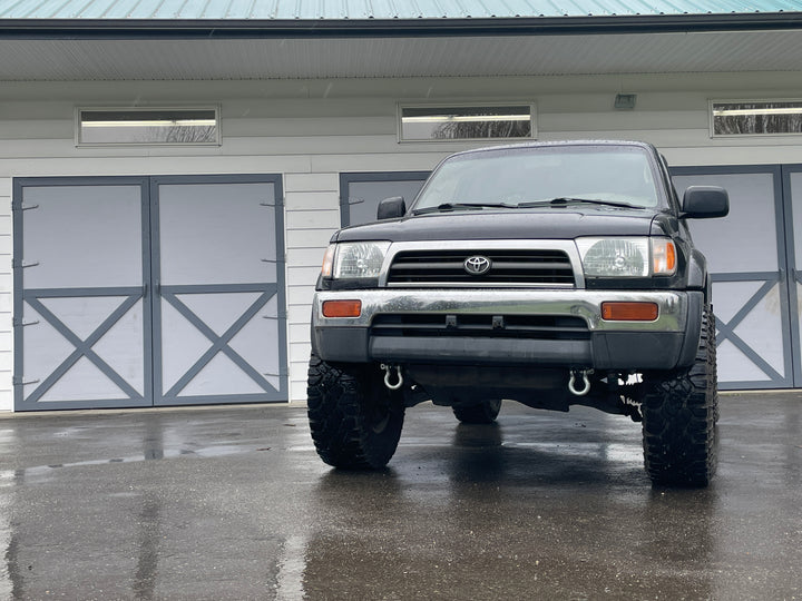 Black 3rd generation Toyota 4Runner equipped with BPF 3rd gen 4Runner Tow Hook Set 1996-2002, featuring heavy-duty tow hooks mounted on the front bumper.