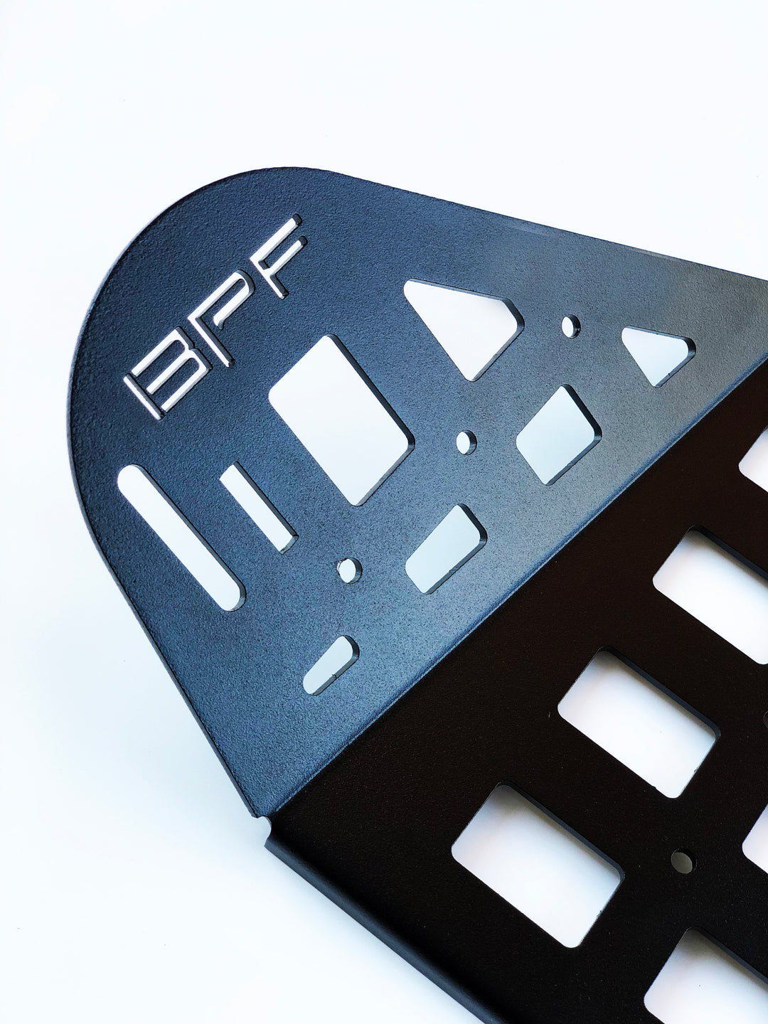 Close-up of a black powder-coated storage panel featuring laser-cut BPF branding and multiple geometric cutouts, part of the BPF 2010-2024 4Runner Storage Panels designed for overlanding gear and 4Runner accessories.