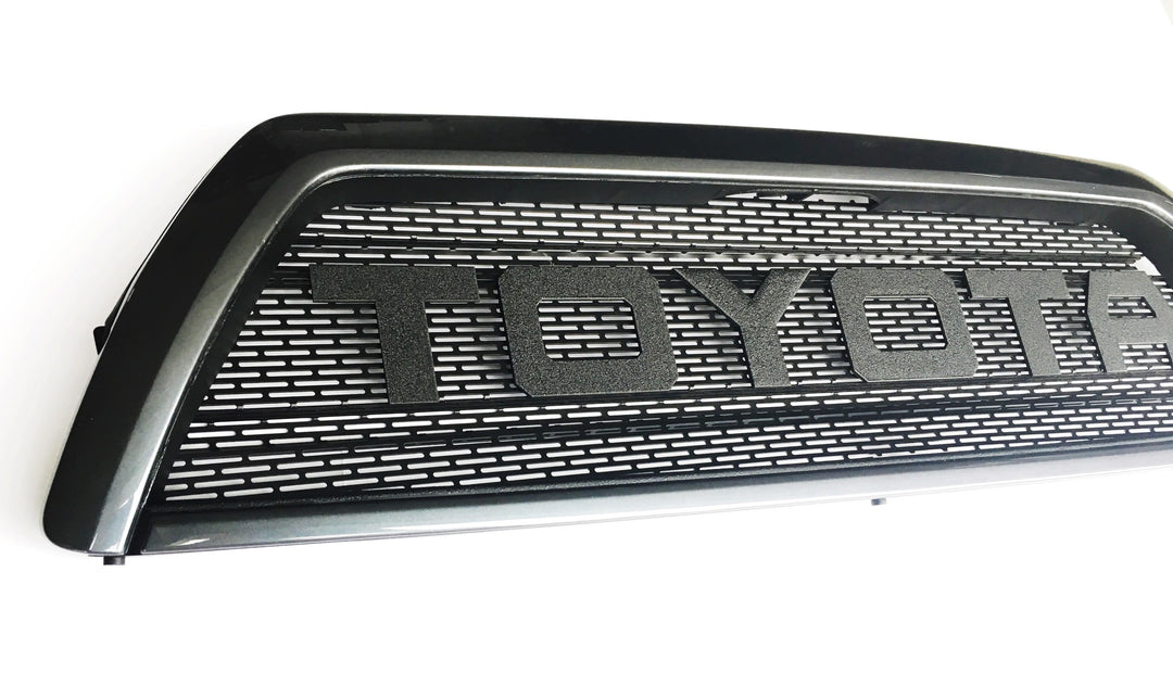 BPF 03-09 Toyota 4runner Grill with a black powder-coated finish featuring bold TOYOTA lettering and a durable mesh design for an OEM fitment appearance.