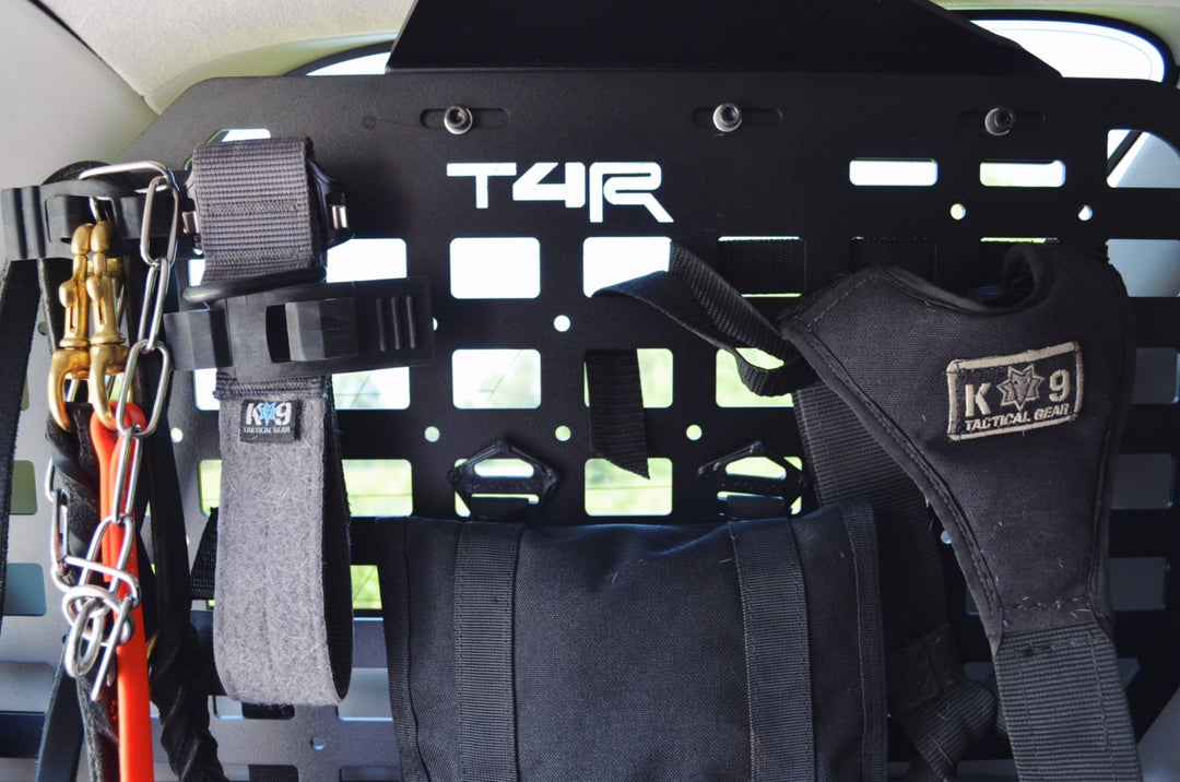 Interior view of a vehicle fitted with BPF 2010-2024 4Runner Storage Panels featuring mounted tactical gear and accessory straps for organized overlanding and outdoor equipment storage.