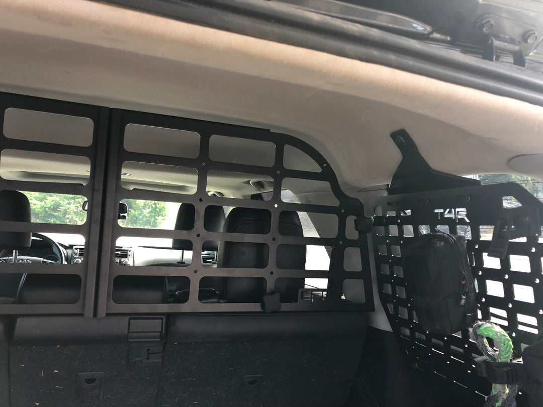 BPF Molle Style Pet Barrier 5th Gen Toyota 4Runner 2010-2024 installed inside vehicle, showing black CNC fabricated grid panel separating cargo area from seats with accessory attachment points.