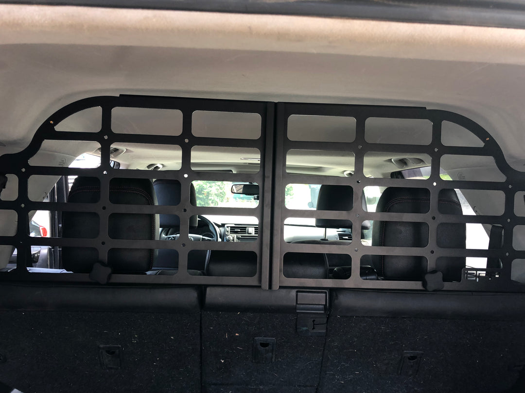 BPF Molle Style Pet Barrier 5th Gen Toyota 4Runner 2010-2024 installed behind rear seats, featuring durable black grid design for safe pet containment in SUV cargo area.