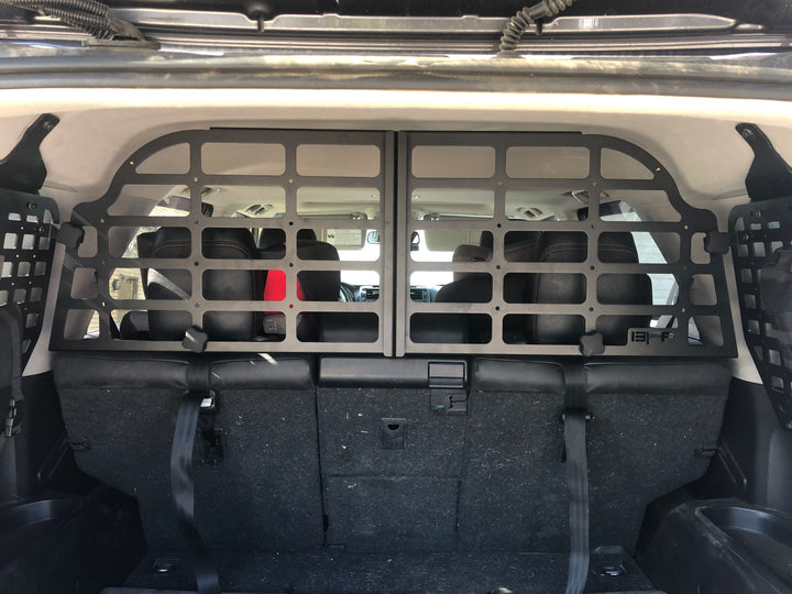 BPF Molle Style Pet Barrier 5th Gen Toyota 4Runner 2010-2024 installed behind rear seats, featuring durable black metal mesh design to keep pets secure in vehicle cargo area.